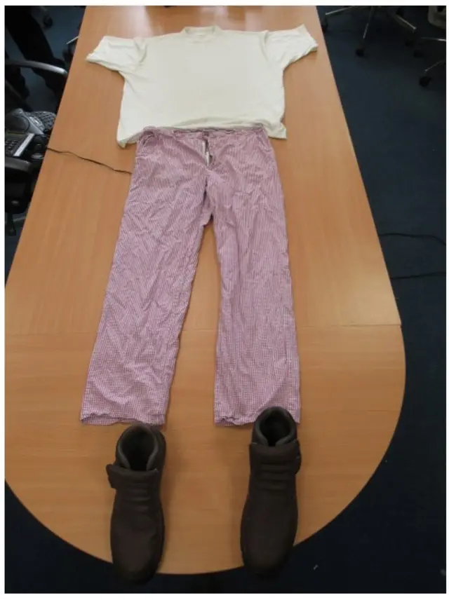 White T-shirt, check trousers and brown boots laid out on a table