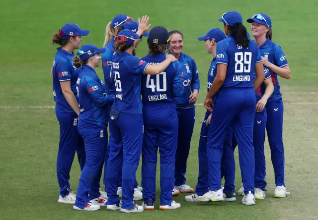England's Amy Jones and England's Alice Capsey celebrates with teammates after taking the wicket of Sri Lanka's Harshitha Samarawickrama