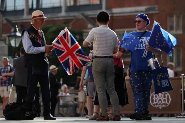People with UK and EU flags