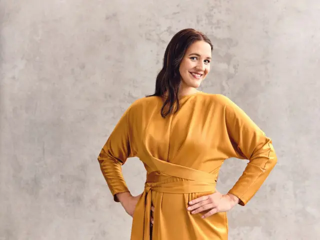 Lise Davidsen dressed in a yellow outfit and smiling
