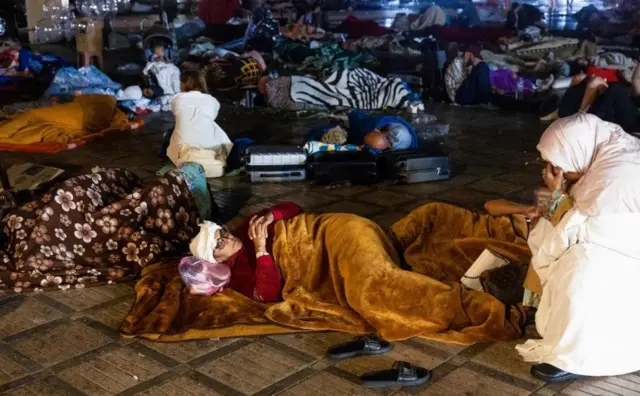 Marrakesh residents fill a square at night, 9 Sep 23
