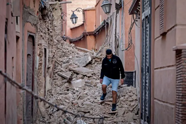 A resident navigates through the rubble following a 6.8-magnitude quake in Marrakesh