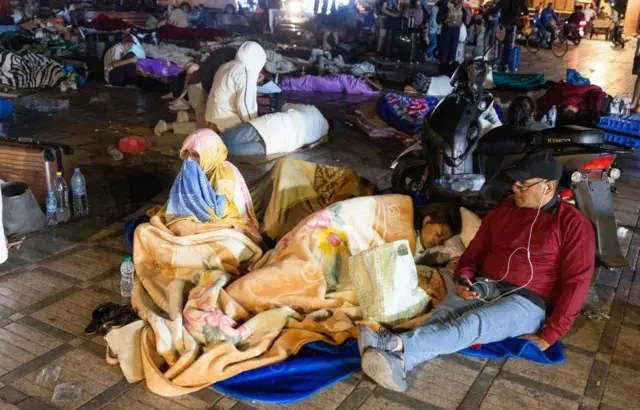 Marrakesh residents lying in a square at night, 9 Sep 23