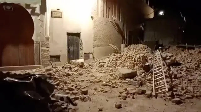 Screengrab of video showing a pile of rubble on a street at night