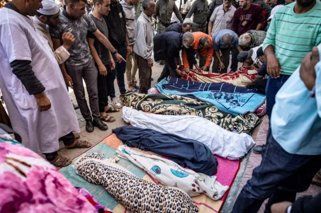 Relatives mourn in front of the bodies of the victims killed in an earthquake in Moulay Brahim, Al Haouz province