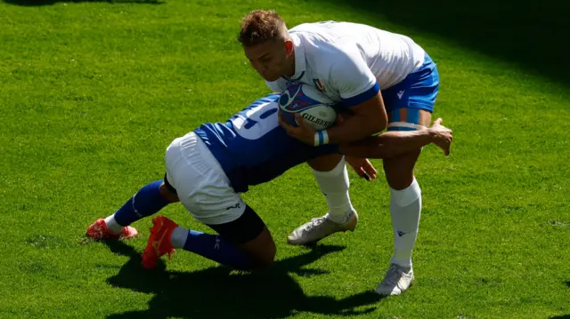 Italy player tackled by Namibia player