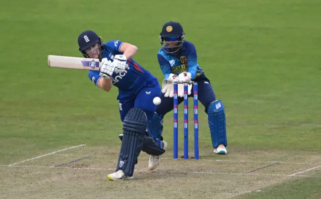 Emma Lamb plays a shot