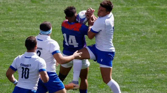 Italy and Namibia players contest a high ball