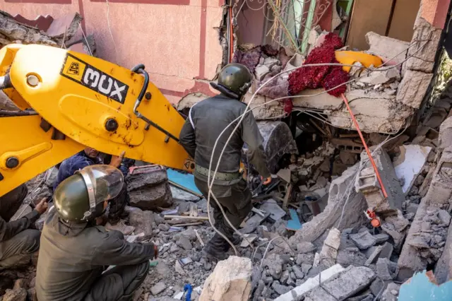 Rescuers search for survivors under the rubble