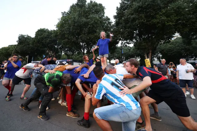 Fans gather as a woman sings outside the stadium prior to the Rugby World Cup France 2023 match between England and Argentina at Stade Velodrome