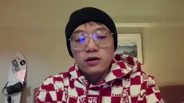 Snowboarder speaking into phone screen