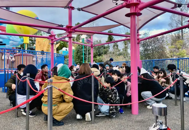 Visitors crouch down as an earthquake hit the region at Universal Studios Japan in Osaka, Japan January 1, 2024
