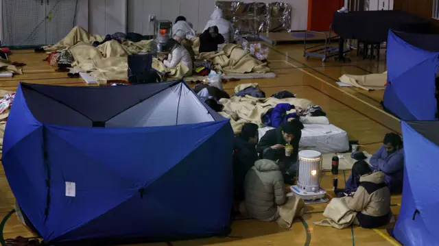 Local residents take shelter at an elementary school acting as an evacuation shelter after in Kanazawa