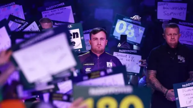 Luke Littler walks out at the Alexandra Palace