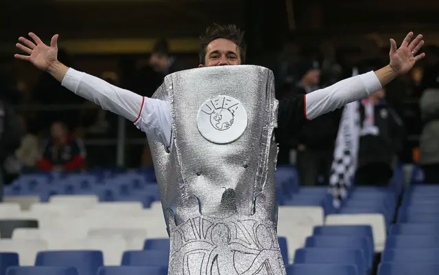 A Fulham fan dressed as the Europa League trophy.