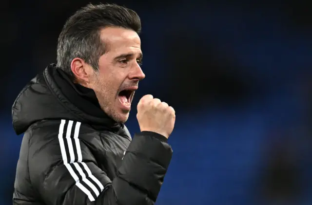 Marco Silva fist bumps and shouts joyously at the Fulham fans.