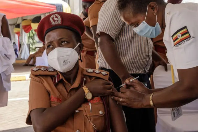 An Ugandan prison officer receives the first injection of the Oxford AstraZeneca Covid-19 vaccine at Mulago referral hospital in Kampala, on the first day of a vaccination campaign on March 10, 2021.