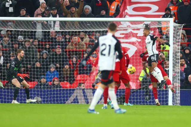 Decordova Reid rises highest to head a goal for Fulham at Anfield.