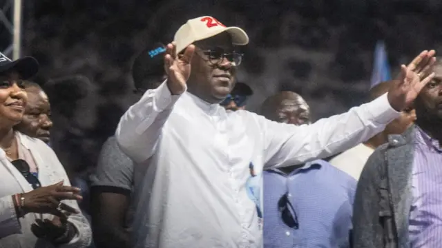 Democratic Republic of the Congo's President Felix Tshisekedi flanked by first lady Denise Nyakeru salutes supporters during a campaign rally at the Afia stadium in Goma, North Kivu province of the Democratic Republic of Congo December 10, 2023