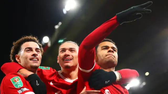 Liverpool players celebrate taking the lead against Fulham