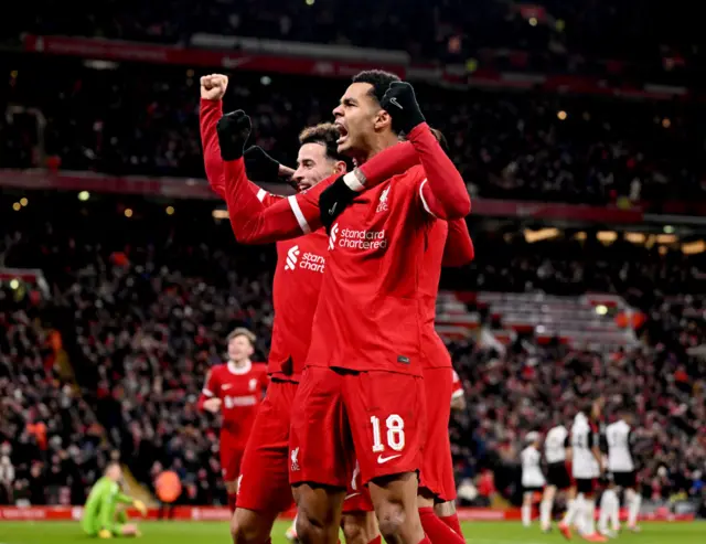 Liverpool players celebrate with would-be matchwinner Gakpo after his goal.