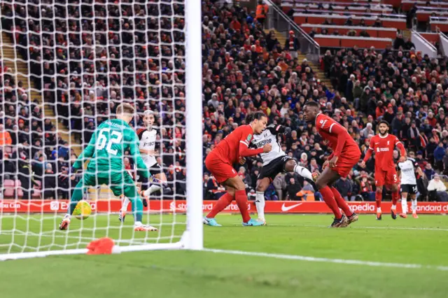 View from behind the goal as Willian fires Fulham in front through a crowd of defenders.