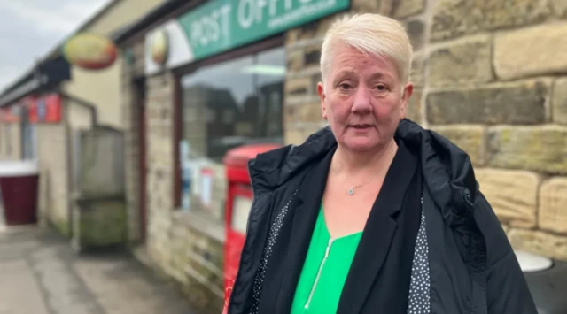 Alison Hall stood outside a Post Office