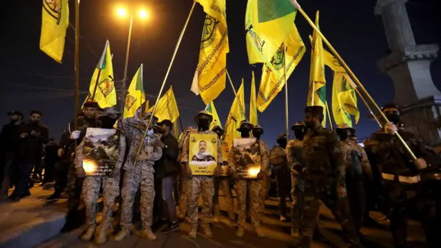 Iraqi militia members hold a funeral procession on 4 January for a leader killed in a US drone strike