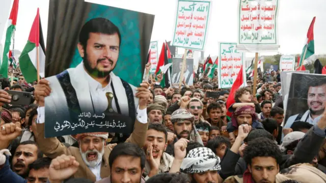 Yemenis seen holding a picture of the Houthi leader at a pro-Palestinian protest last month