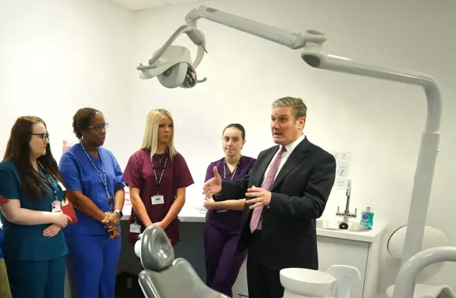 Labour leader Sir Keir Starmer (right) speaks to dental students and staff during a visit to Bury college in Lancashire