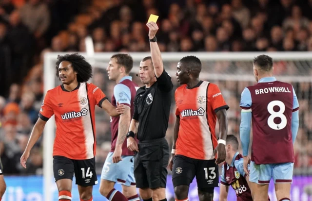 Tahith Chong shown a yellow by referee Peter Bankes whilst playing against Burnley