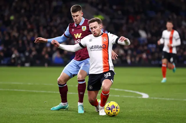 Jordan Clark of Luton Town on the ball whilst under pressure from Johann Gudmundsson