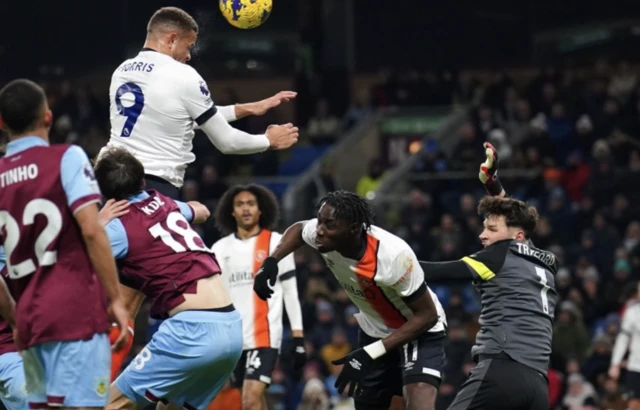 Calton Morris heads the ball as James Trafford is obstructed