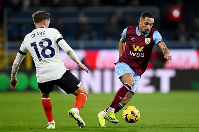 Vitinho of Burnley on the ball whilst under pressure from Jordan Clark