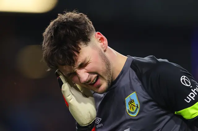 James Trafford of Burnley reacts holding his face