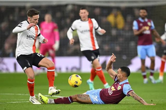 Jordan Clark (L) vies with Burnley's Brazilian defender #22 Vitinho