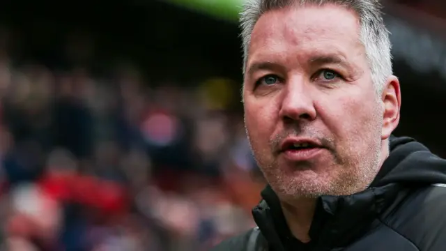 Darren Ferguson stands on the touchline