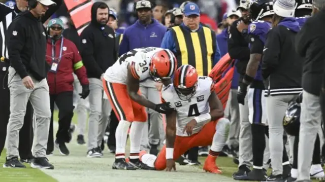 Deshaun Watson is helped up by Jerome Ford after being tackled