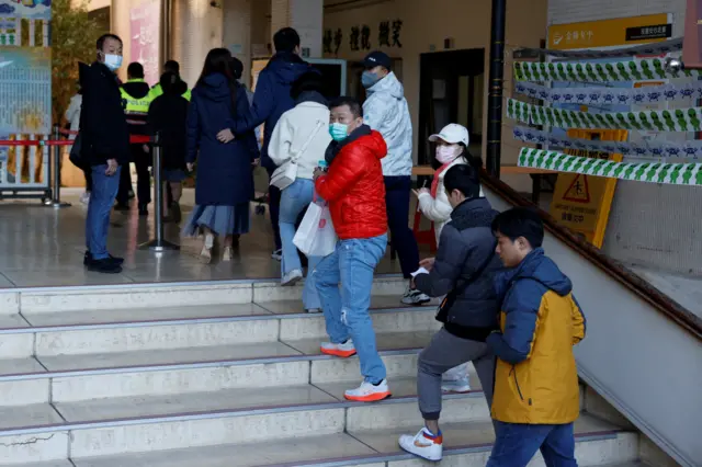 People queuing to vote