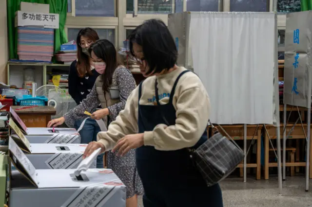 Voters casting their vote at a polling station in Taipei