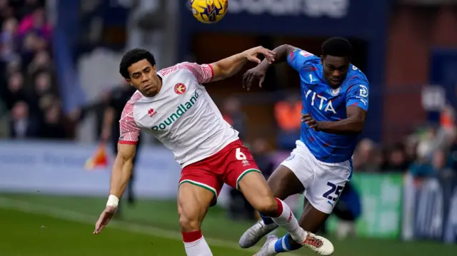 Stockport and Walsall players tussle for the ball