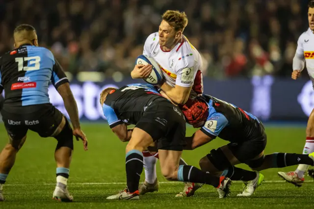 Alex Dombrandt of Harlequins is tackled by Tinus de Beer