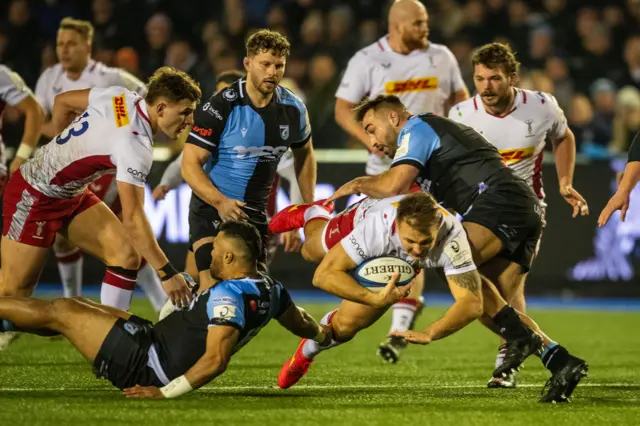 Andre Esterhuizen of Harlequins is tackled by Liam Belcher of Cardiff Rugby