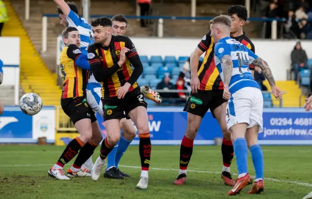 Morton's Robbie Crawford (right) heads towards goal