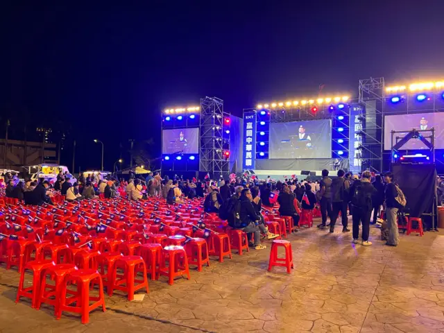 Rows of stools with Taiwan flags sit empty at the KMT victory rally in Banqiao