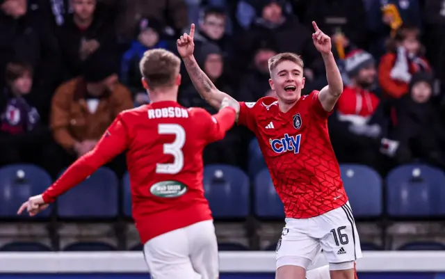 Queen's Park's Cameron Bruce (right) celebrates