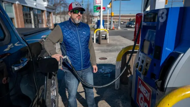 A driver fills up his petrol tank in Alexandria, Virginia