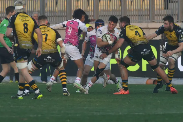 Lorenzo Pani of Zebre is tackled by Sean Lonsdale of Dragon