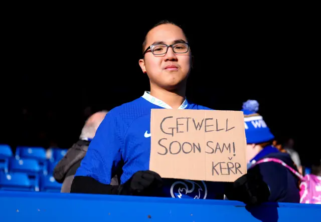 A fan holds up a poster in support of Sam Kerr