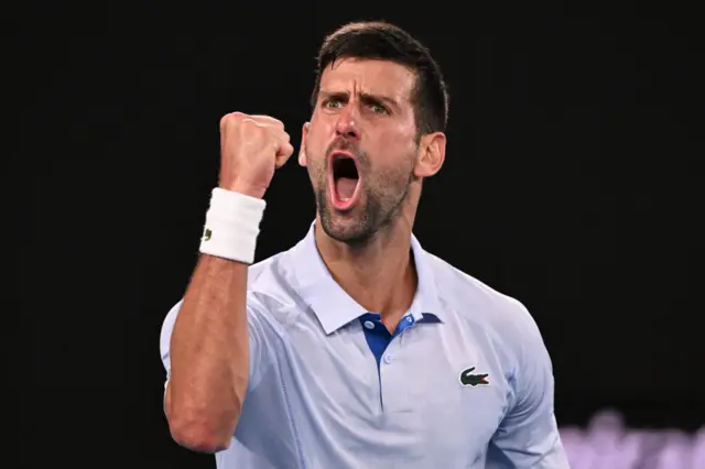 Novak Djokovic roars in celebration after winning the third set